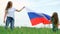 4k. Happy mother and daughter waving national Russia flag outdoors green grass at summer - russian flag, country