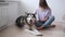 4k. Happy woman pet alaskan malamute dog lying on floor.