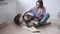 4k. Happy woman pet, scratch alaskan malamute dog lying on floor.