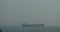 4k Huge container oil tanker ship on ocean,modern building background.