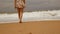 4K. legs feet Asian girl walking barefoot on wet sand island beach with big wave on summer season. vintage color tone