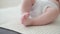 4k. little baby boys tiny bare feet on white plaid. Newborn. Happy family