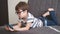 4k. little cute caucasian boy in glasses study in phone