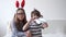 4k. little cute caucasian exiceted girl and boy in bunny ears. easter