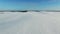 4K. Low flight above snow fields in winter, aerial view (Snow desert)