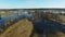 4K. Low flight and takeoff over flooded blue river in early spring, aerial panoramic view