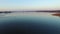 4K. Low flight and takeoff over wild lake with ducks in early spring on sunset, aerial.