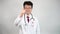 4K. Middle-aged Asian male doctor raising thumb up and making an OK sign.