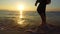 4K panning man running in shallow sea at sunset