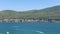 4K Panoramic view of the bay with the emerald Aegean Sea, yachts, white sand, green mountains. Luxury conception