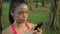 4K Portrait asian woman runner used phone for sport in the beautiful park.