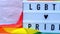 4k Rainbow flag with lightbox and text LGBTQ PRIDE. Rainbow lgbtq flag made from silk material. Symbol of LGBTQ pride