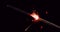 4k resolution closeup of Firework sparkler burning in slowmotion, black background