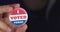 4k resolution closeup video of a hand holding I voted today button. Elections concept