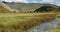 4k river on the prairie,clouds mass rolling over mountains,far away temple.