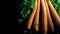 4k. A row of carrots with water drops with the tops cut off rotates a wooden Board on a black background