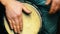 4k shot of a man playing on a Bongo drum close up. Hand tapping a Bongo