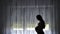 4K Silhouette of pregnant woman watching the window