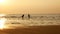 4K. silhouette of sister and brother running and playing in water at the beach on sunset. beauty and joyful teenager friends