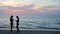 4K Silhouette woman checking social media on smart phone on the beach