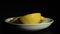 4k. Sliced lemon slices rotate on a white plate