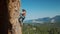 4k slow motion of Athletic man climbs an vertical rock with rope, lead climbing. silhouette of a rock climber on a
