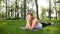 4k slow motion footage of mid aged smiling woman practicing yoga in the public park at sunny summer day. Concept of body