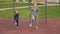 4K slow motion Mother and daughter doing exercises on open air sport playground. Sportive family