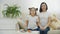 4k slow motion video of mother and daughter on white sofa posing for a video.