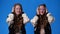 4k slow motion video of twin girls closing their ears.