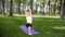 4k slow motion video of yoga and fitness on grass at park. Middle aged smiling woman practicing and doing exercises on