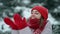 4k slow motion young pretty smiling happy woman in red mittens and hat wearing parka walking in park in snow, warm