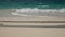 4K. soft wave of the summer beach holiday ,couple of man and woman walking as foreground on the white sand beach with clear water.