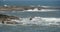 4k sparkling ocean sea water waves surface & coastal rock coast surge shore.