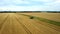 4K spectacular straight down zoom out rotating aerial view of two combine harvesters harvesting wheat