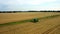 4K spectacular straight down zoom out rotating aerial view of two combine harvesters harvesting wheat