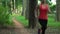 4K Sports lifestyle. Road runner young asian woman running on path in park