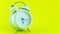 4k Stop motion animation timelapse of beautiful classic analog Alarm clock moving fast on Yellow Wall background White alarm clock