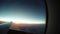 4K The SUN ascending from behind the horizon - a view from the plane in flight