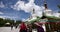 4k tibet people turn spinning buddhist prayer wheels,Potala & white stupa.