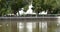 4k tibet people turn spinning buddhist prayer wheels,Potala & white stupa,lake surface.