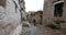 4k tibet woman walking on the lhasa drepung, famous tibetan temple.