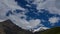 4K Timelaps Clouds slowly swim among the Caucasus mountains green and ice scenic peaks in summer sunrise. Sun lights and shadow