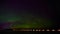 4K timelapse of aurora borealis in northern Sweden with dancing green and purple light beside a lake