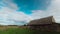 4k Timelapse. Clouds Above Old Barn. Summer Colorful Dramatic Sky With Cumulus Clouds Above Old Village Building