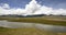 4k timelapse clouds mass rolling over Tibet mountain,River flowing the prairie.