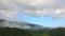 4k Timelapse of fog and clouds moving in the blue sky over the mountain during summer in the tropical rainforest park, Thailand