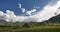 4k timelapse puffy clouds mass rolling over Tibet mountaintop & valley.