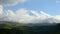 4k timelapse swirling clouds on a snow-covered mountain sleeping Elbrus volcano at sunset. Green hills with gorges in