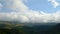 4k timelapse swirling clouds on a snow-covered mountain sleeping Elbrus volcano at sunset. Green hills with gorges in